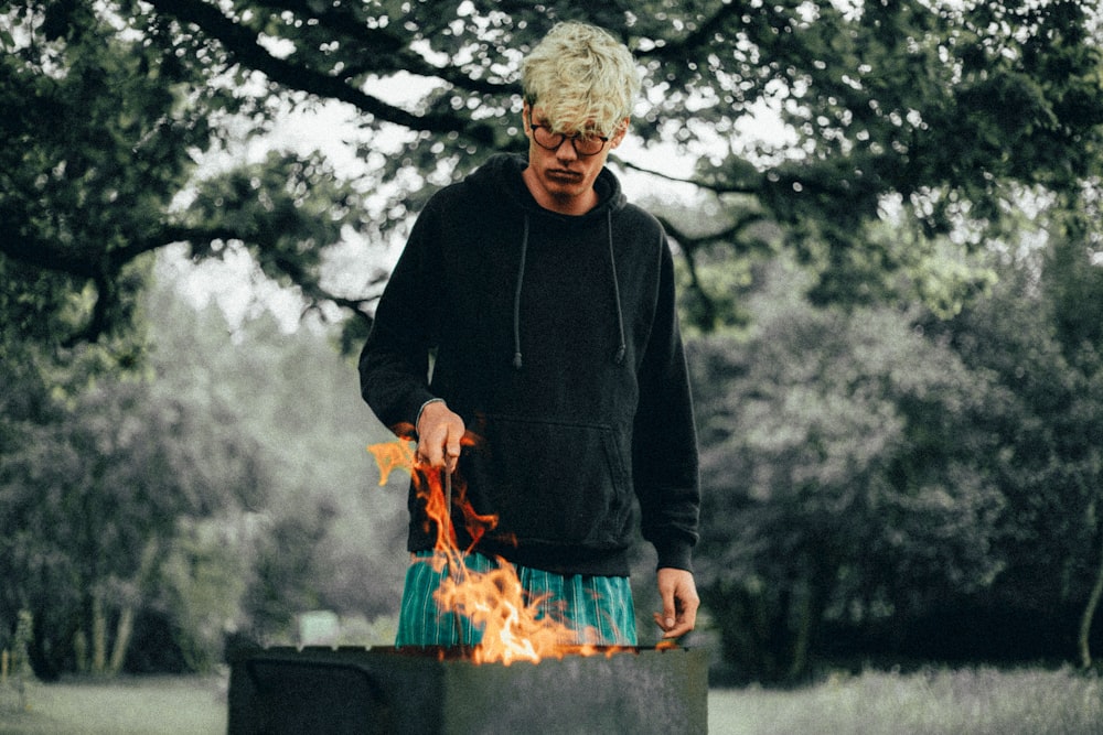 man standing in front of fire