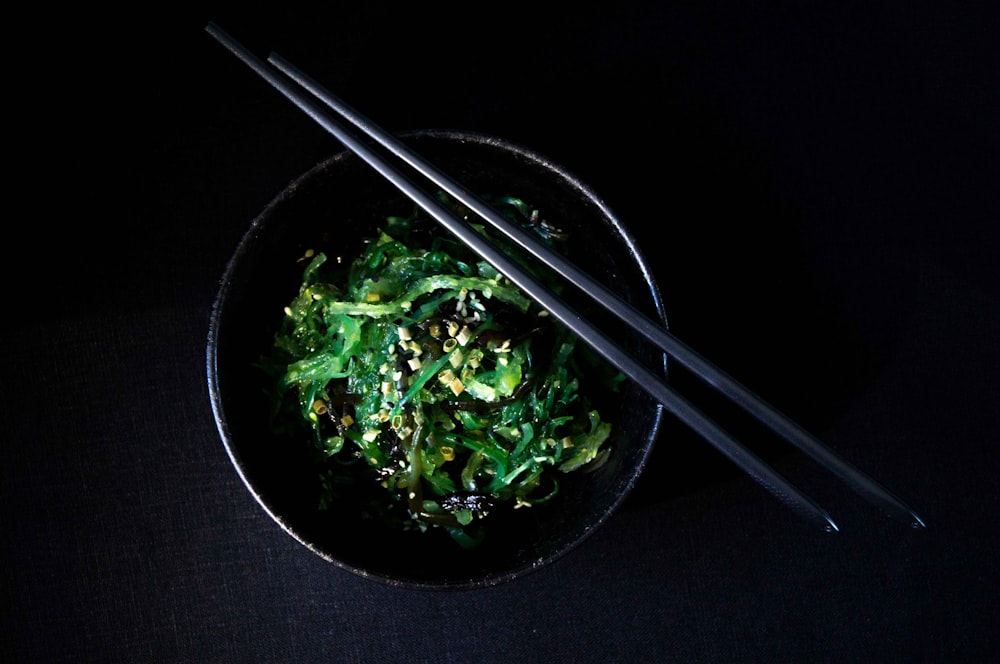 vegetable salad in bowl with chopsticks on top of bowl