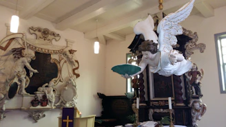 A serene chapel interior bathed in soft light with a statue of the Immaculate Conception.