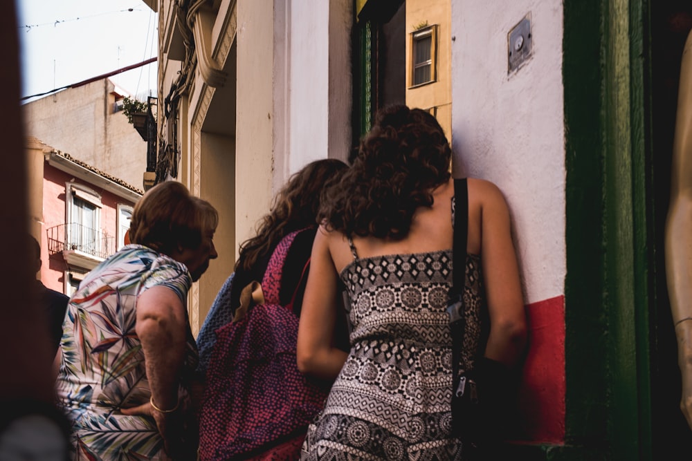 women standing near concrete building