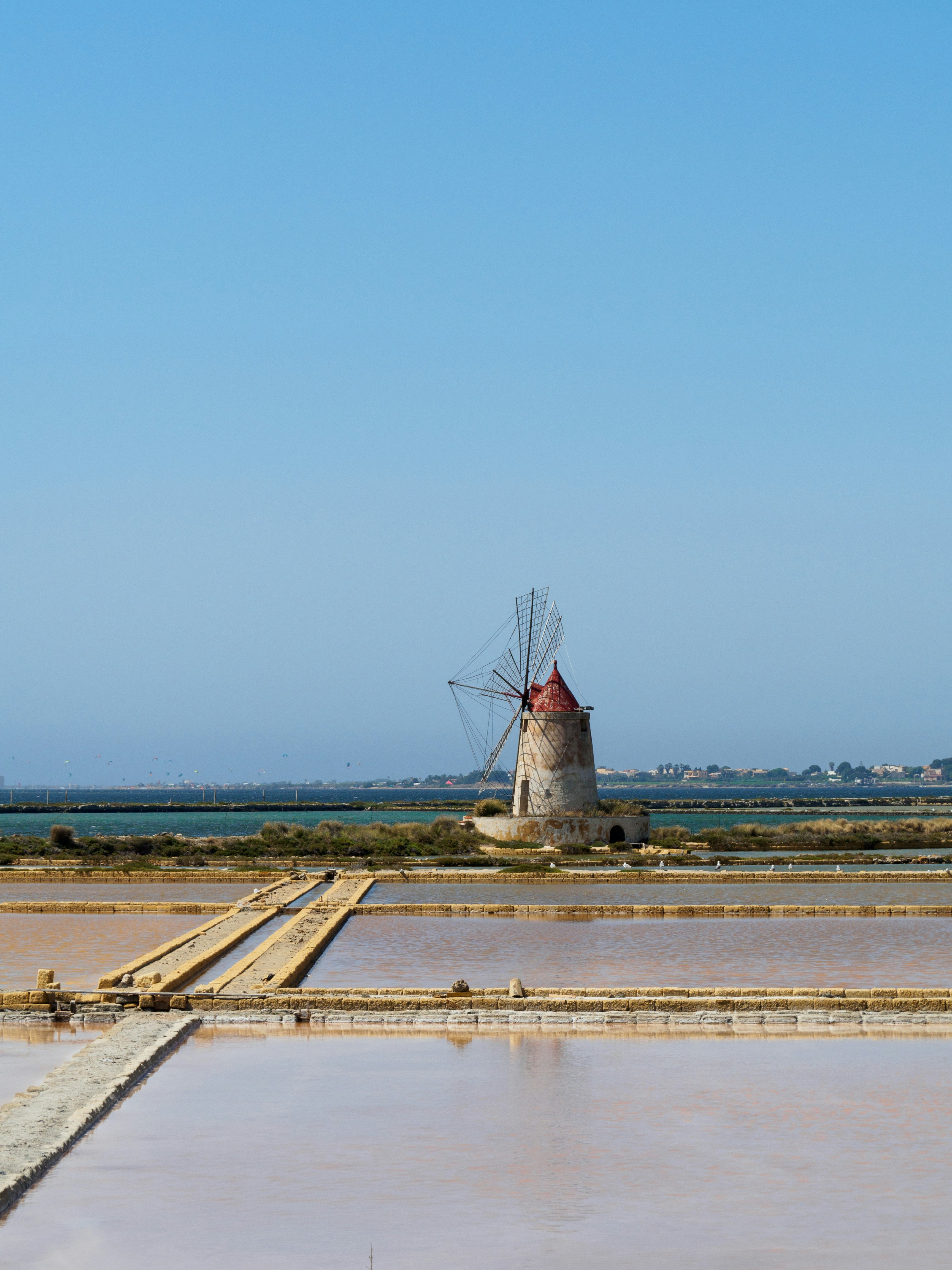 windmill near body of water