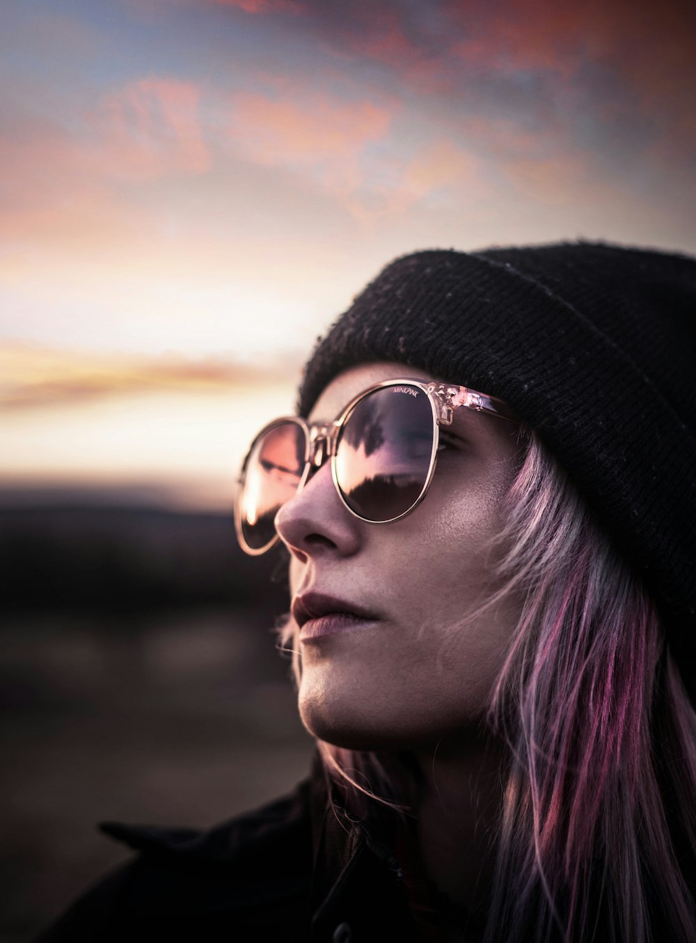 woman with black knit cap with sunglasses