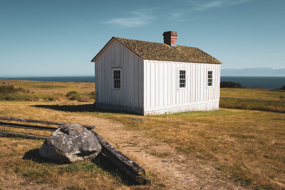 gray stone near white cabin