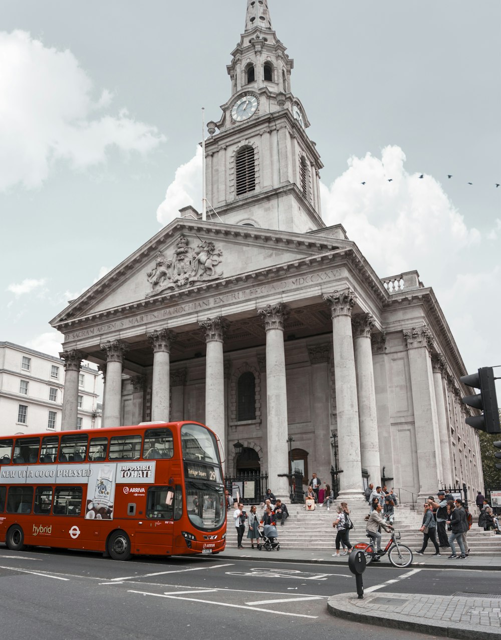 people walking near museum beside red and white bus