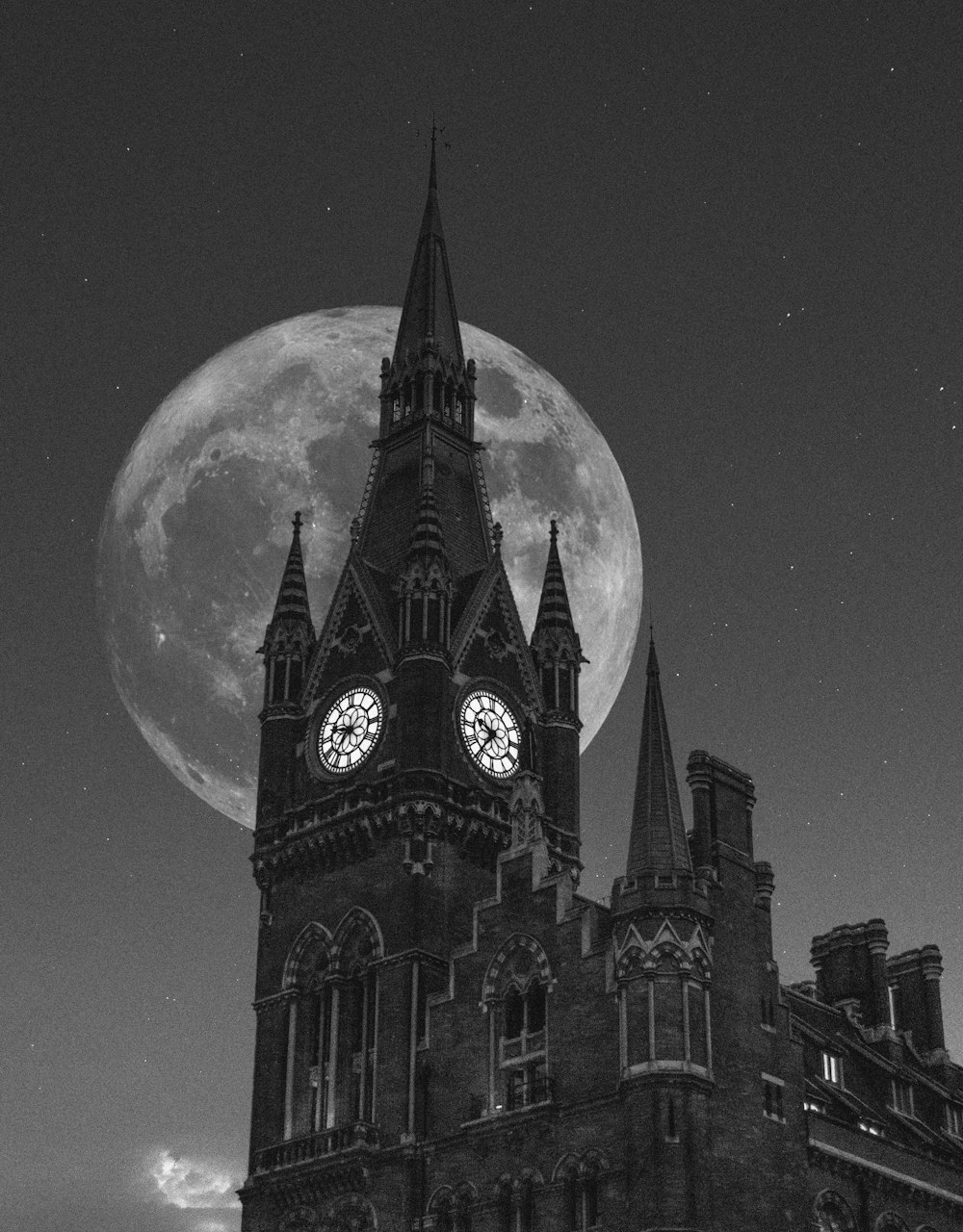 grayscale photo of Westminster Abbey showing full moon