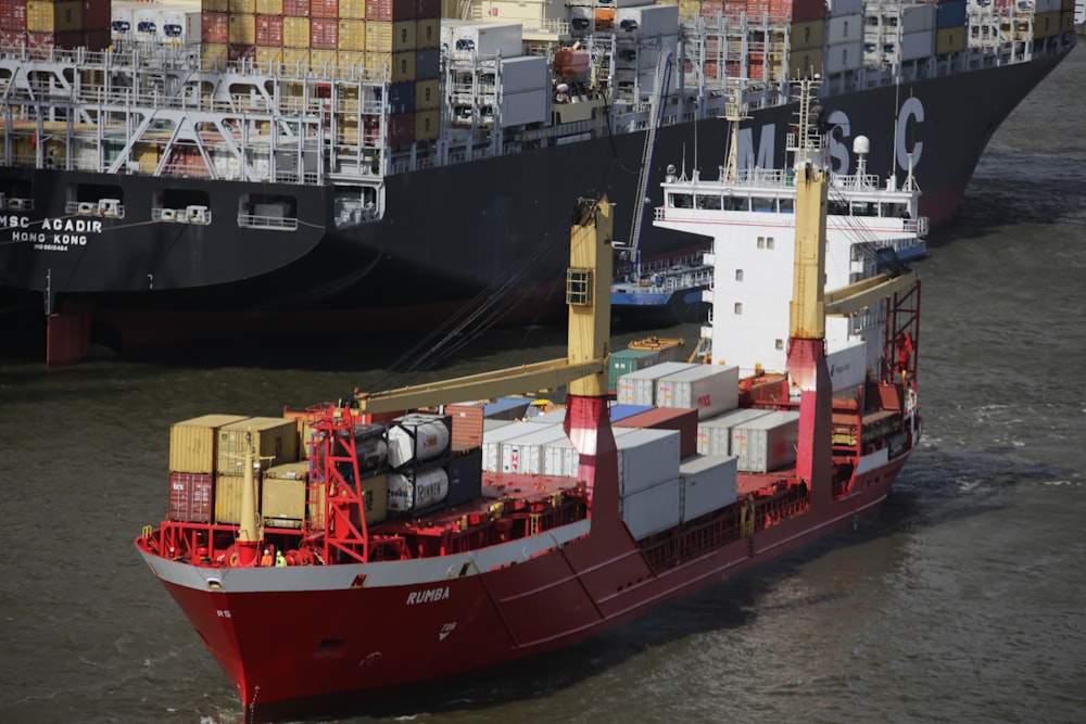 red and white cargo ship beside dock