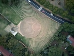 aerial photo of cars in highway passing park