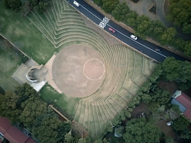 aerial photo of cars in highway passing park