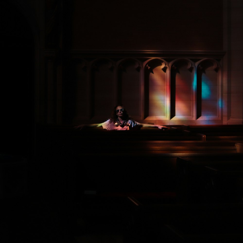 a person laying on a bed in a dark room