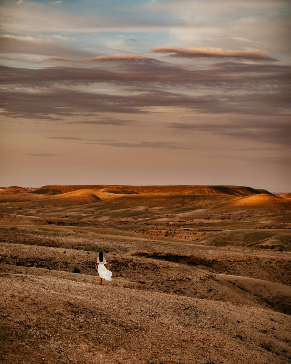 woman standing on brown field