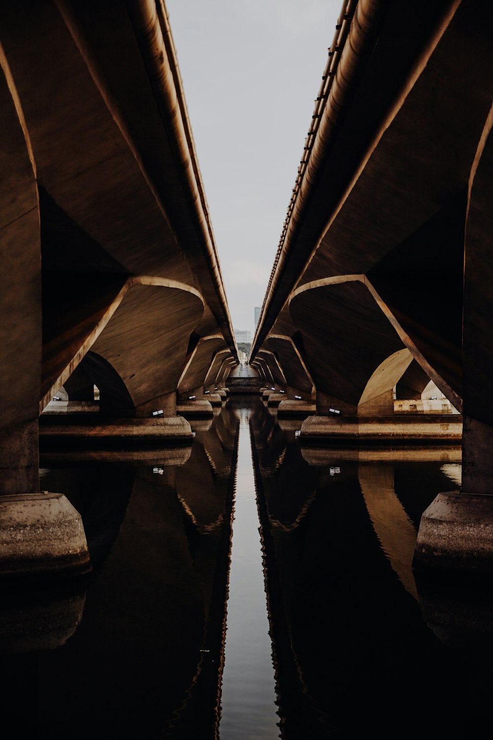 a view of the underside of a bridge over water