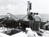 A group of professionals discussing marine equipment in an office setting.