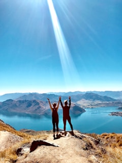 two women standing and raising hands