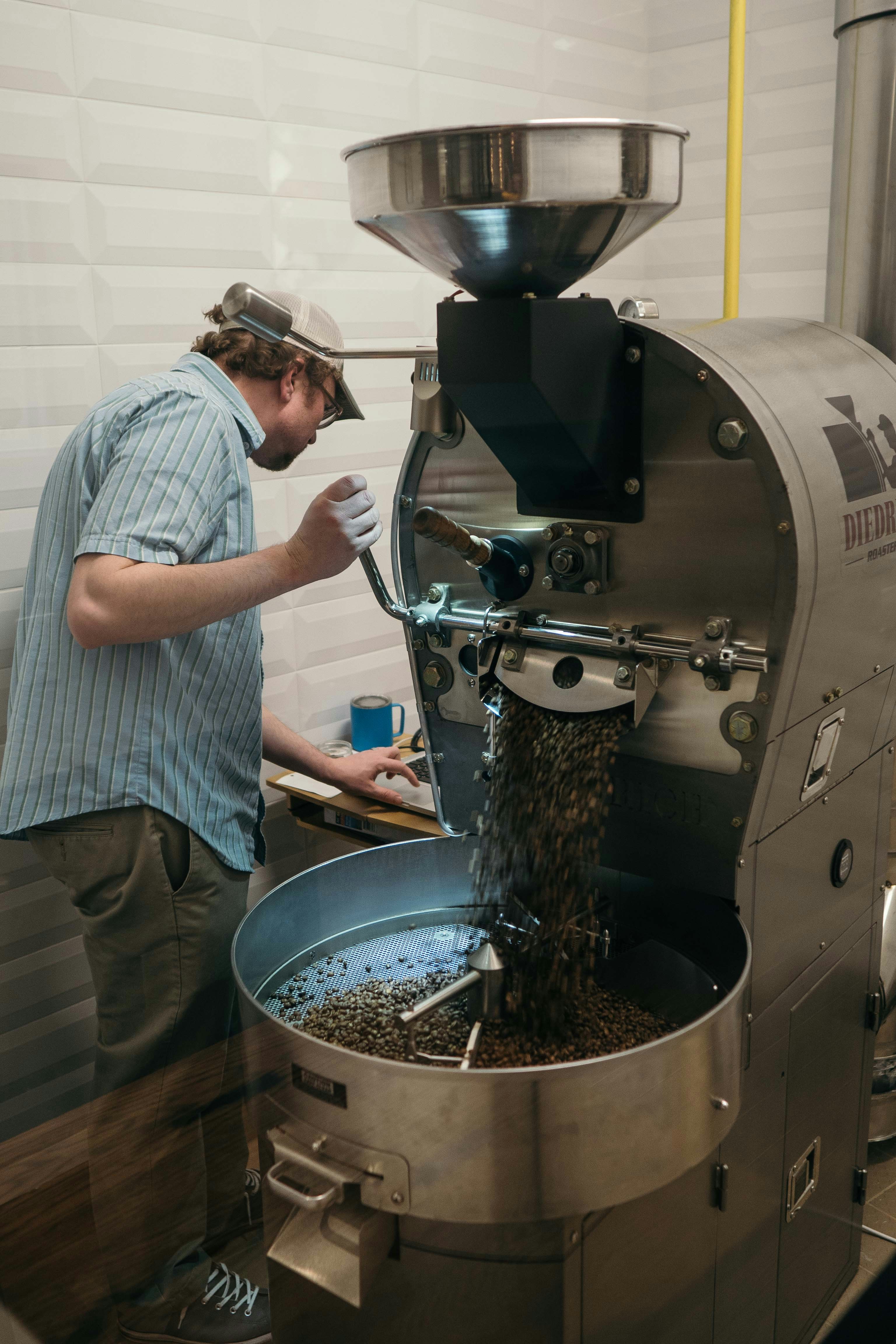 man operating silver metal machine