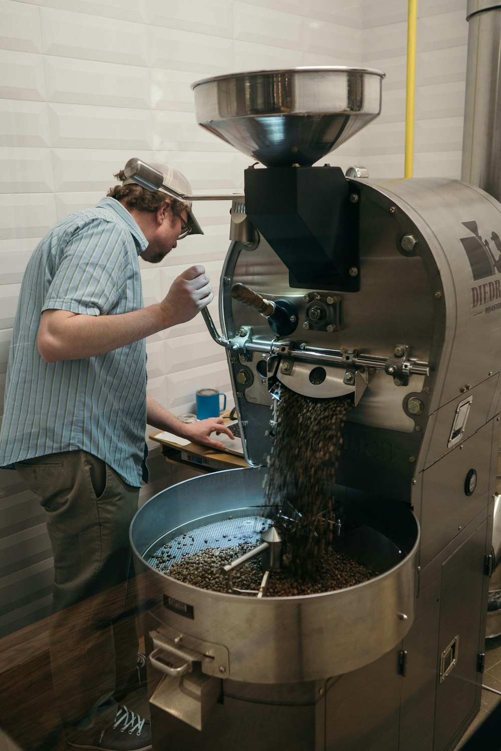 man operating silver metal machine