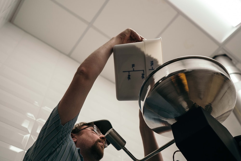 person pouring ingredient to mixer