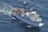 A large research vessel navigates through the ocean, leaving a trail of white foam in its wake. The ship is equipped with various antennas and cranes, highlighting its function for scientific exploration. The vessel's name and identification number are visible on its side.