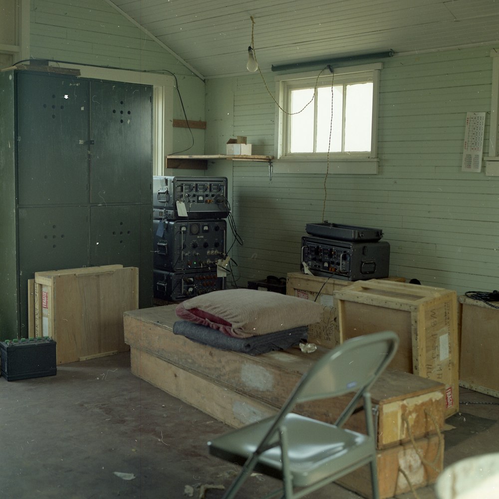 grey metal folding chair beside brown wooden box