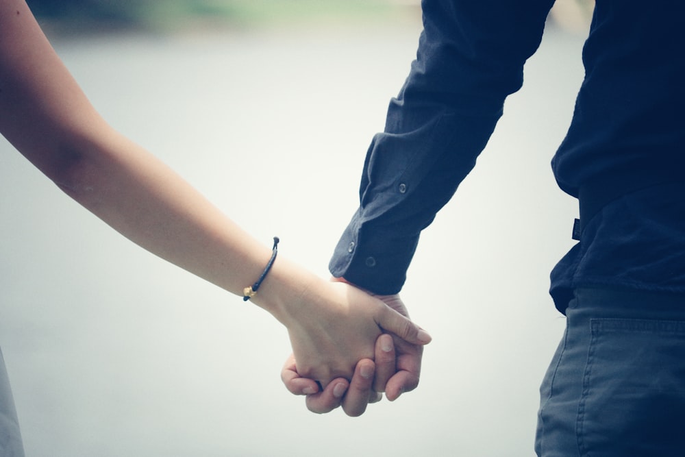 man and woman holding hands