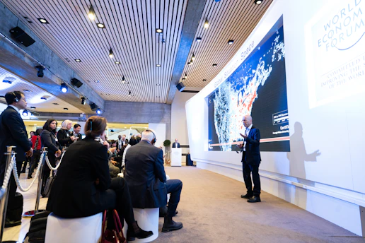 man standing beside projecting wall in front of people