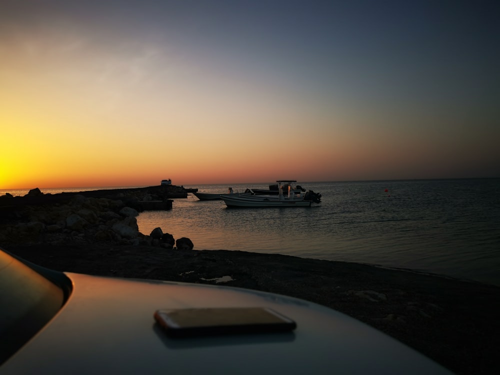 white and black yacht near seashore