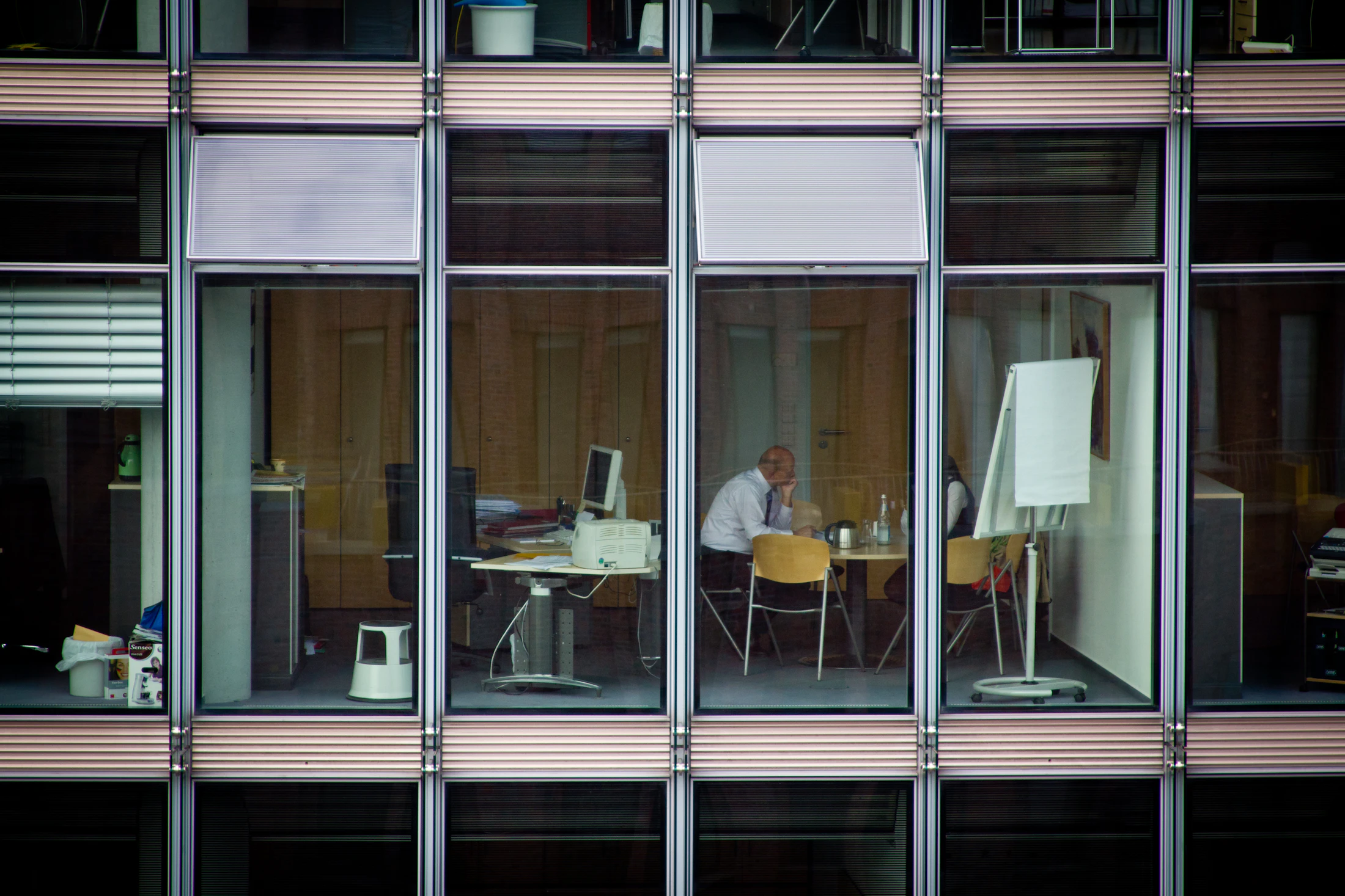 Lit office floors seen from outside after hours