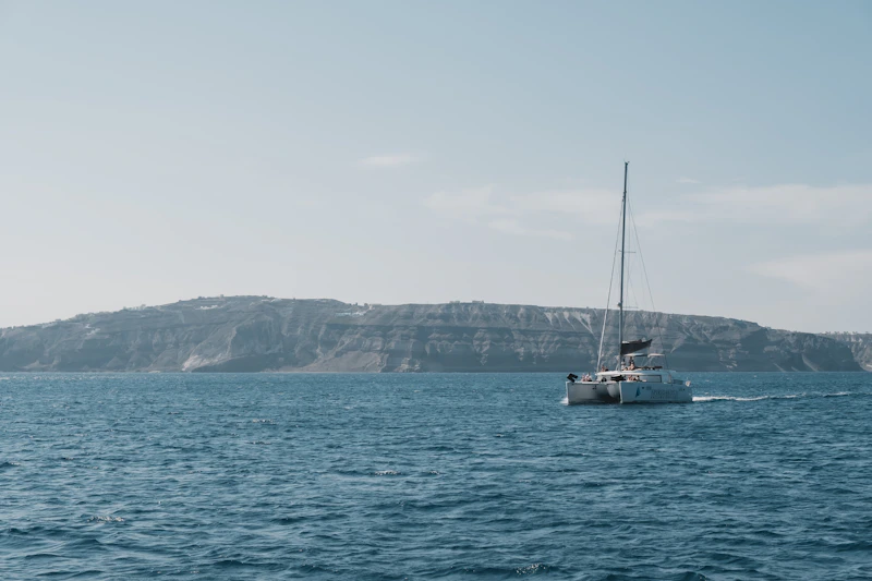 Private catamaran on the turquoise waters of the Santorini caldera