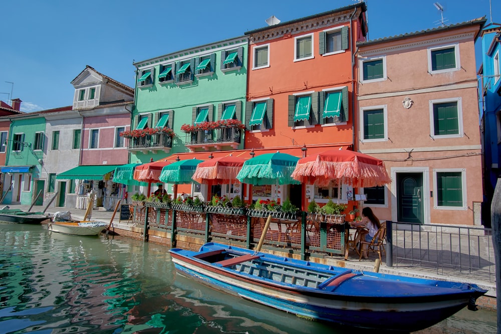 blue boat between buildings