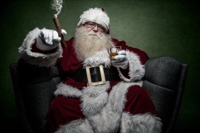 man wearing santa claus costume sitting on chair santa claus google meet background