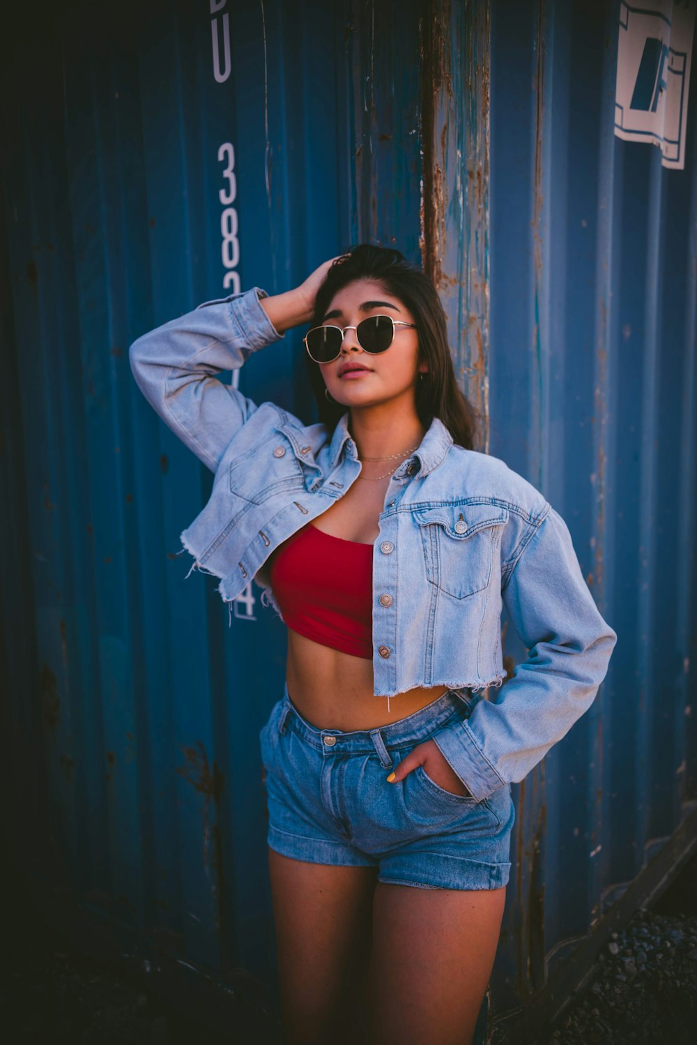 woman in maroon tube top, blue denim jacket and shorts