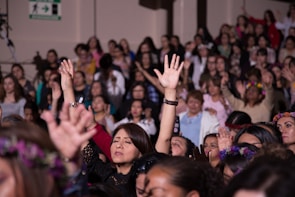 A group of women engaged in a lively workshop, expressing themselves with energy.