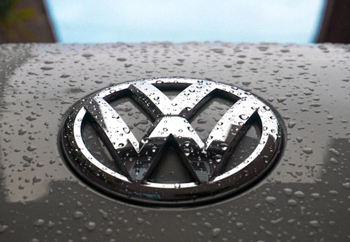 water dew on silver Volkswagen car emblem