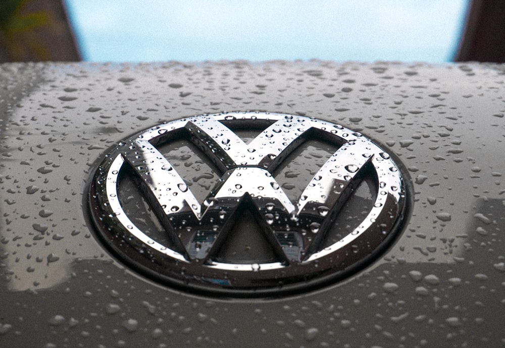 rugiada d'acqua sull'emblema argentato dell'automobile Volkswagen