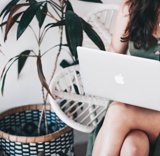 woman sitting and using MacBook