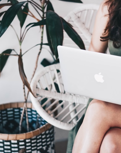 woman sitting and using MacBook