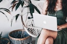 woman sitting and using MacBook