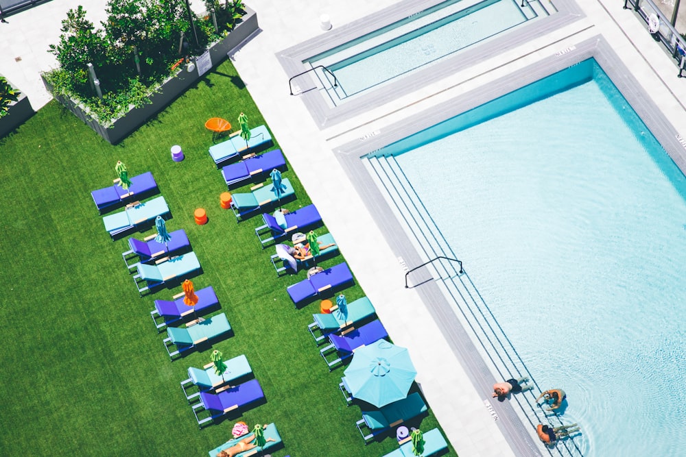aerial photo of sunlounger near water pool