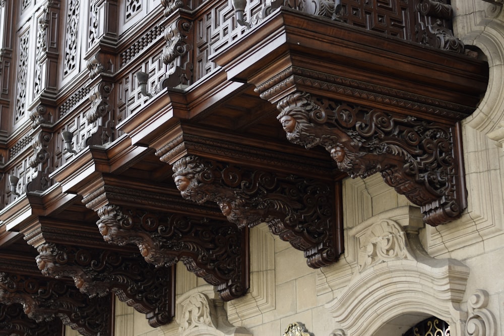 brown wooden floral baluster on white concrete building