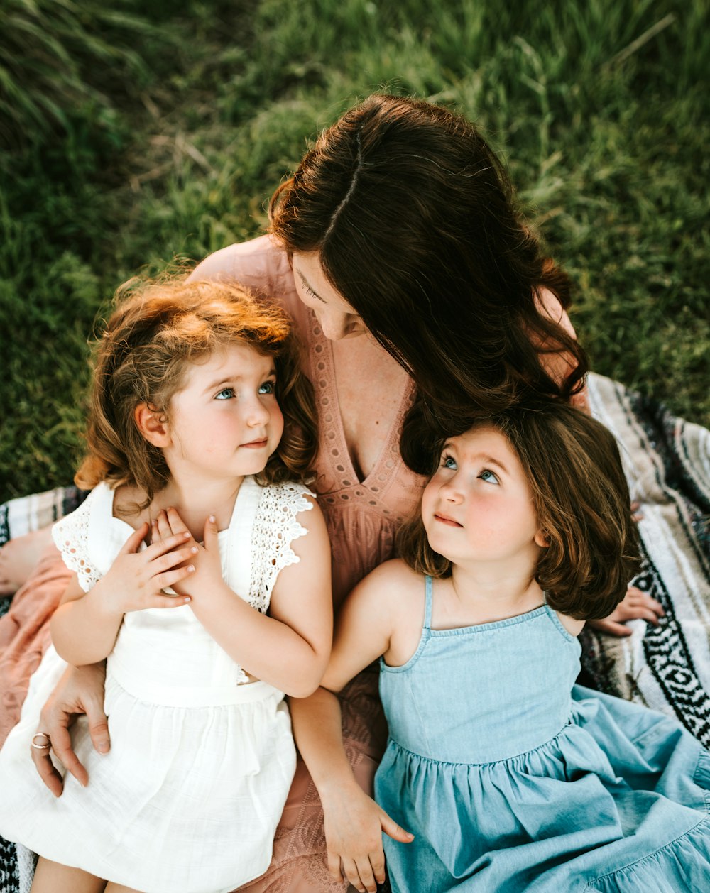 two girl lying on woman lap