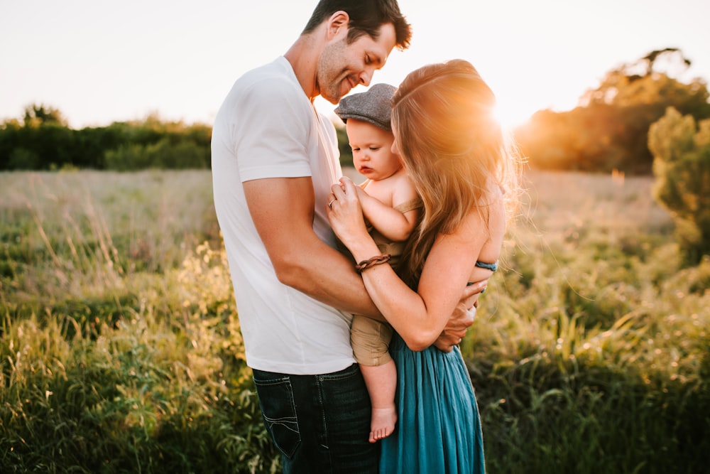 family photo on green grass during golden hour