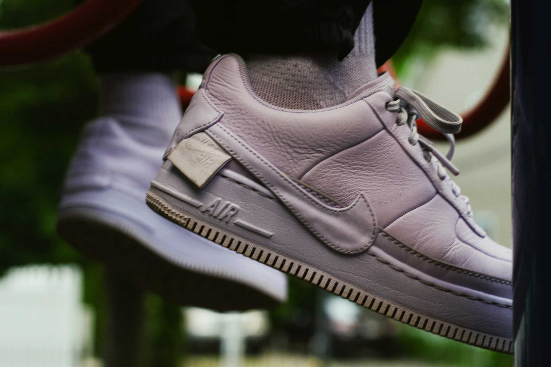 A close-up of windkicks sneakers against a backdrop of a windy beach, highlighting their aerodynamic features.