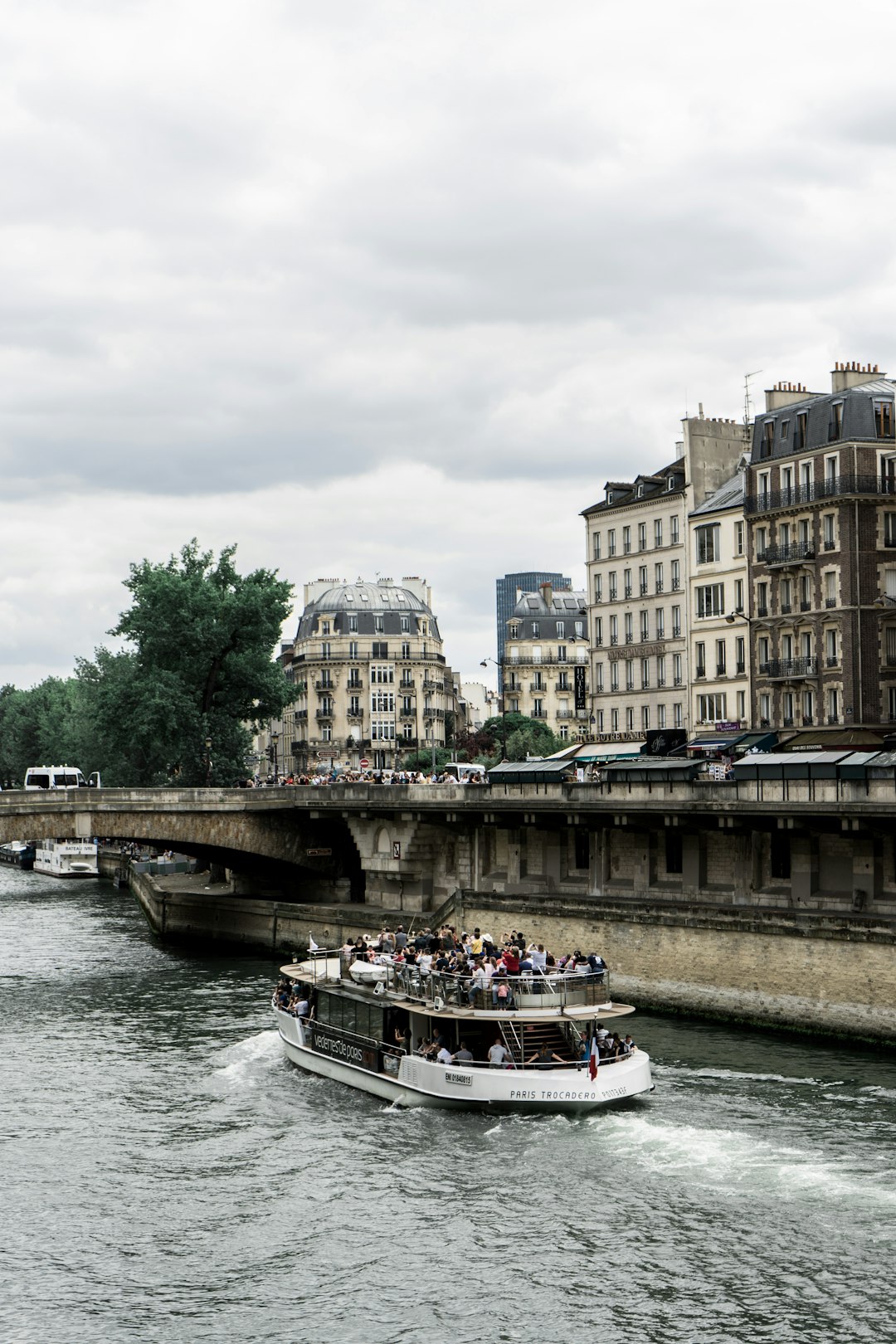 white ship sailing on river near building