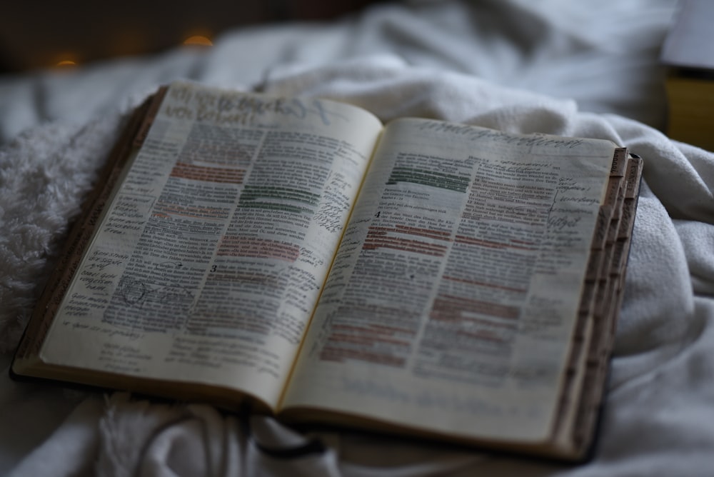 open book on white textile