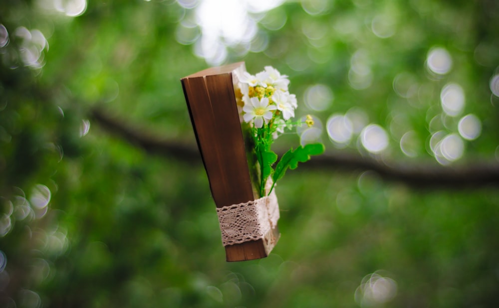 white flowers bounded on brown book