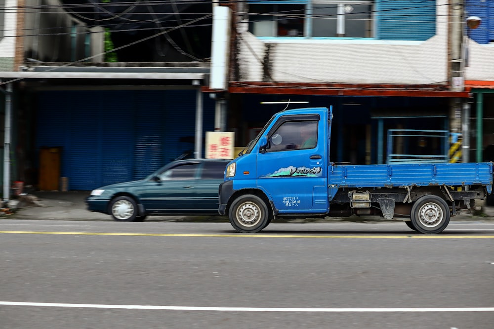 blue vehicle on paved road