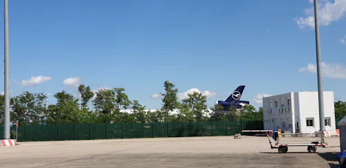 Professional driver checking cargo before departure on a clear day.
