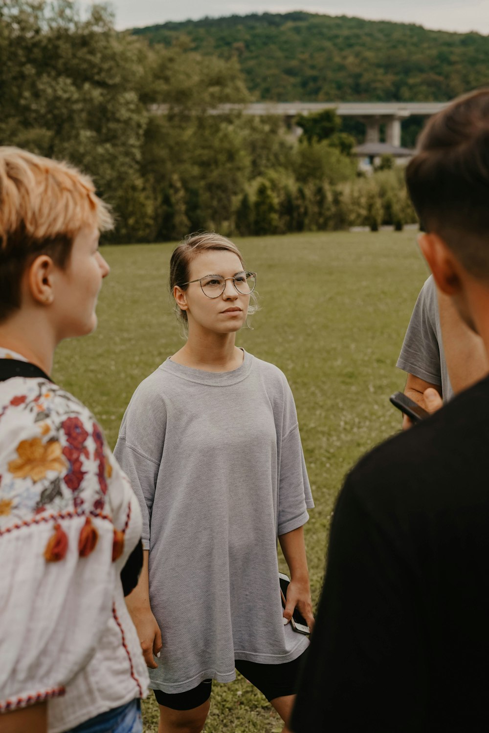 woman wearing gray shirt on green grass