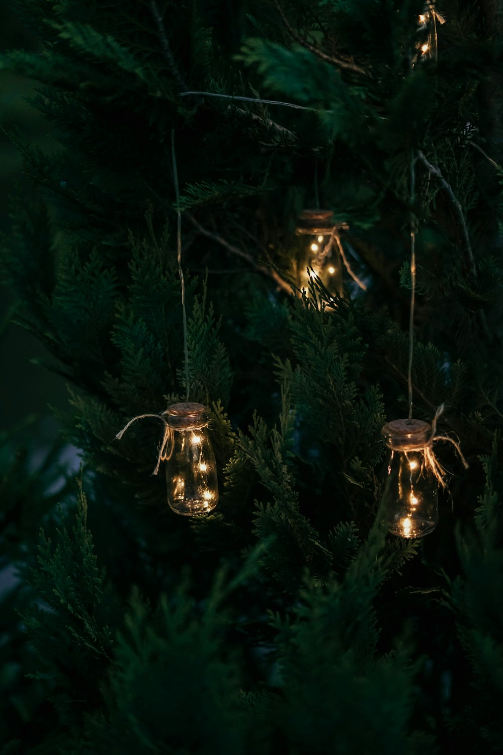 three clear glass jar lights