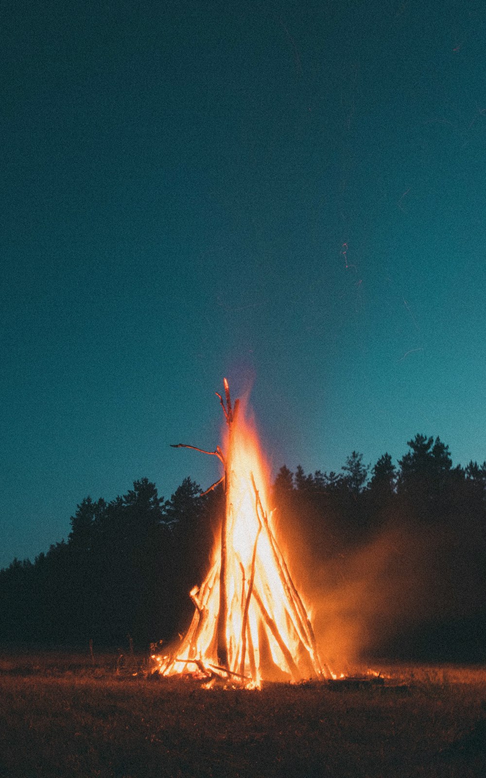bonfire under blue sky during nighttime