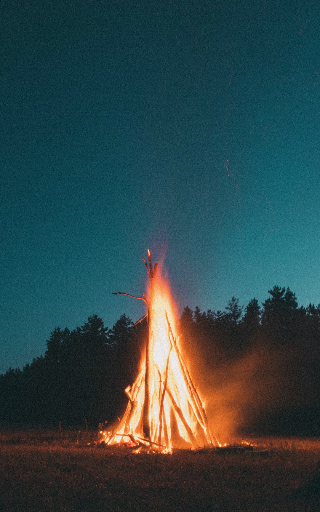 bonfire under blue sky during nighttime